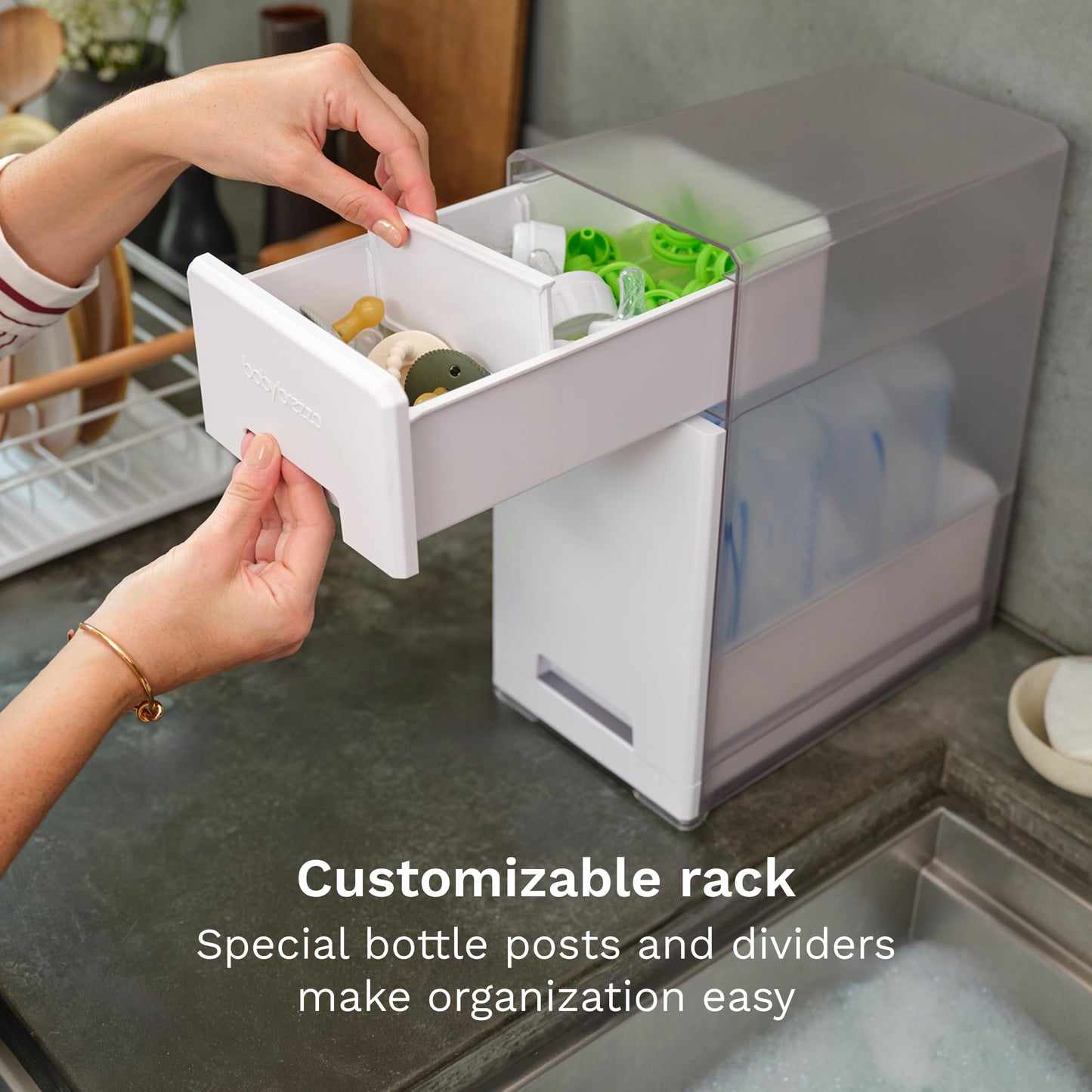 Baby Brezza bottle drying rack holding various baby feeding items