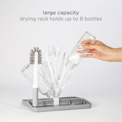 Ubbi drying rack holding baby bottles on kitchen counter