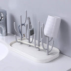 Green cactus shaped bottle rack with drain tray on kitchen counter