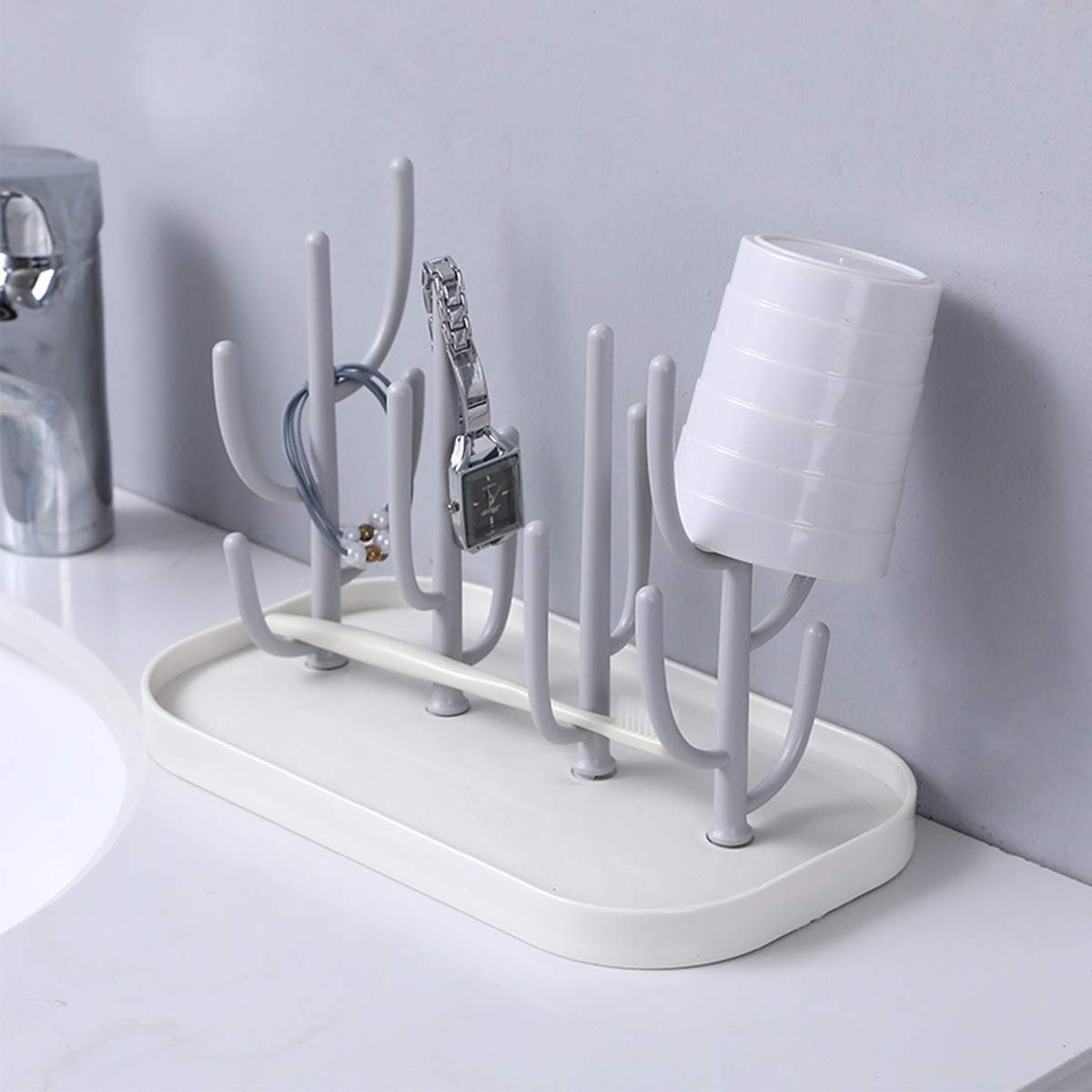 Green cactus shaped bottle rack with drain tray on kitchen counter
