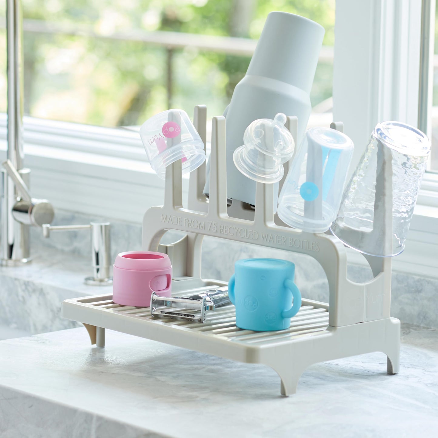 PopYum drying rack holding various baby bottles and tumblers
