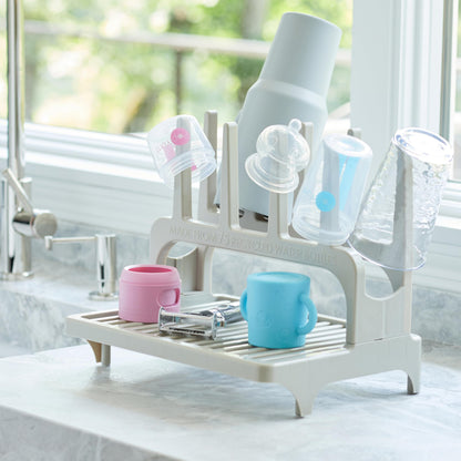 PopYum drying rack holding various baby bottles and tumblers