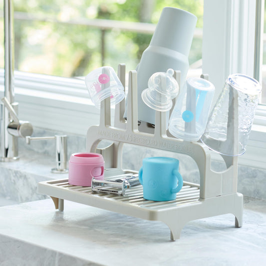PopYum drying rack holding various baby bottles and tumblers