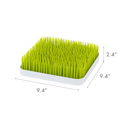 Close up of flexible green grass blades for bottle drying