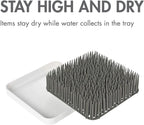 Boon Grass countertop organizer on a kitchen counter