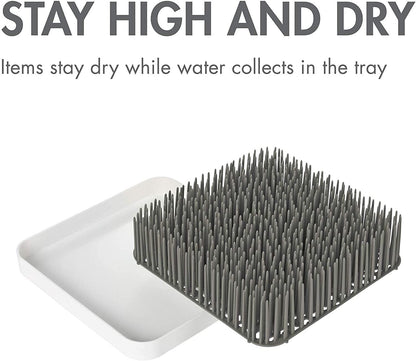 Boon Grass countertop organizer on a kitchen counter