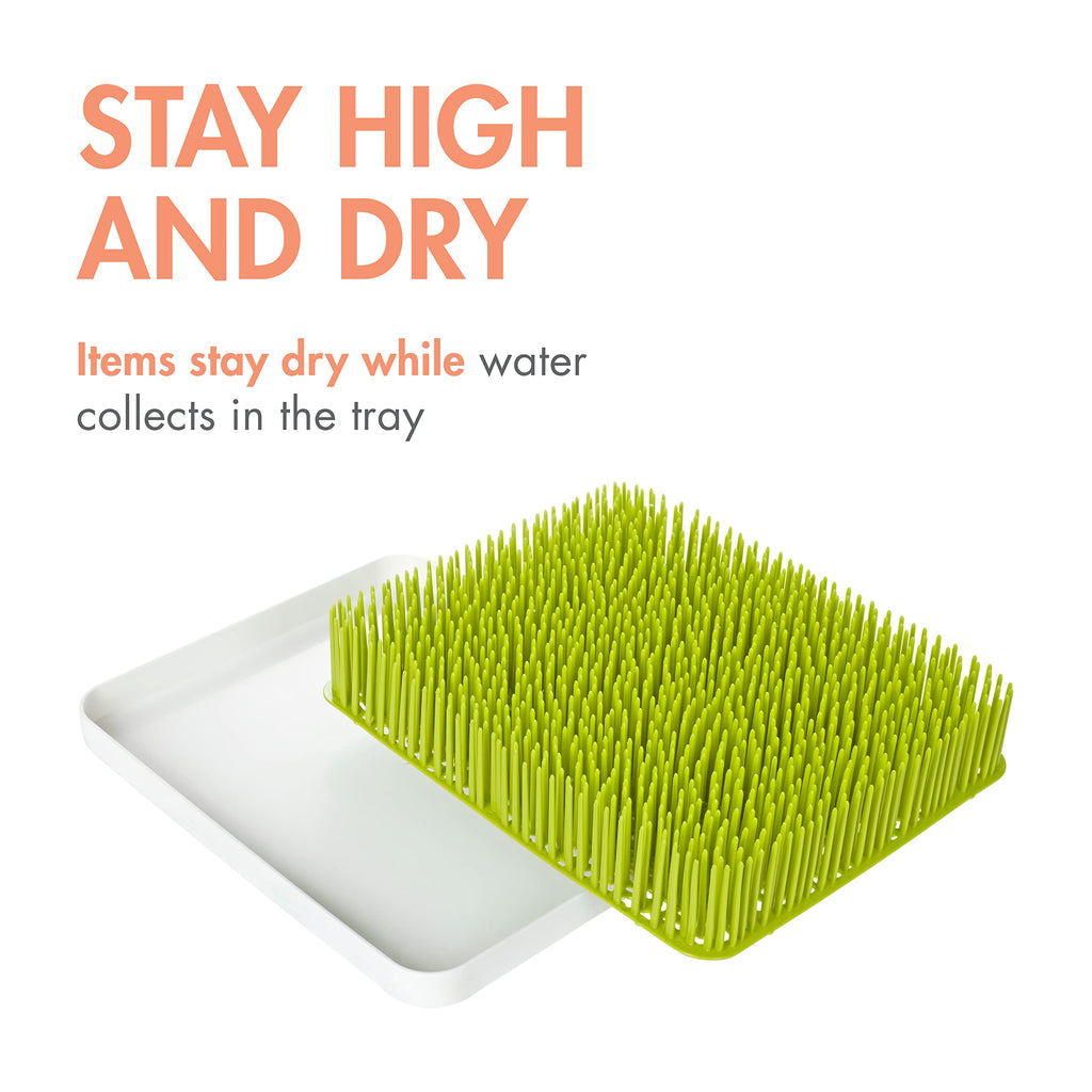Close up of Boon lawn grass blades holding baby bottles