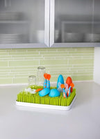 Boon green bottle drying rack showing side profile on kitchen counter