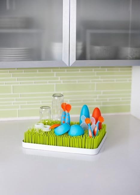 Boon green bottle drying rack showing side profile on kitchen counter
