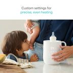 Munchkin bottle warmer with baby bottle inserted