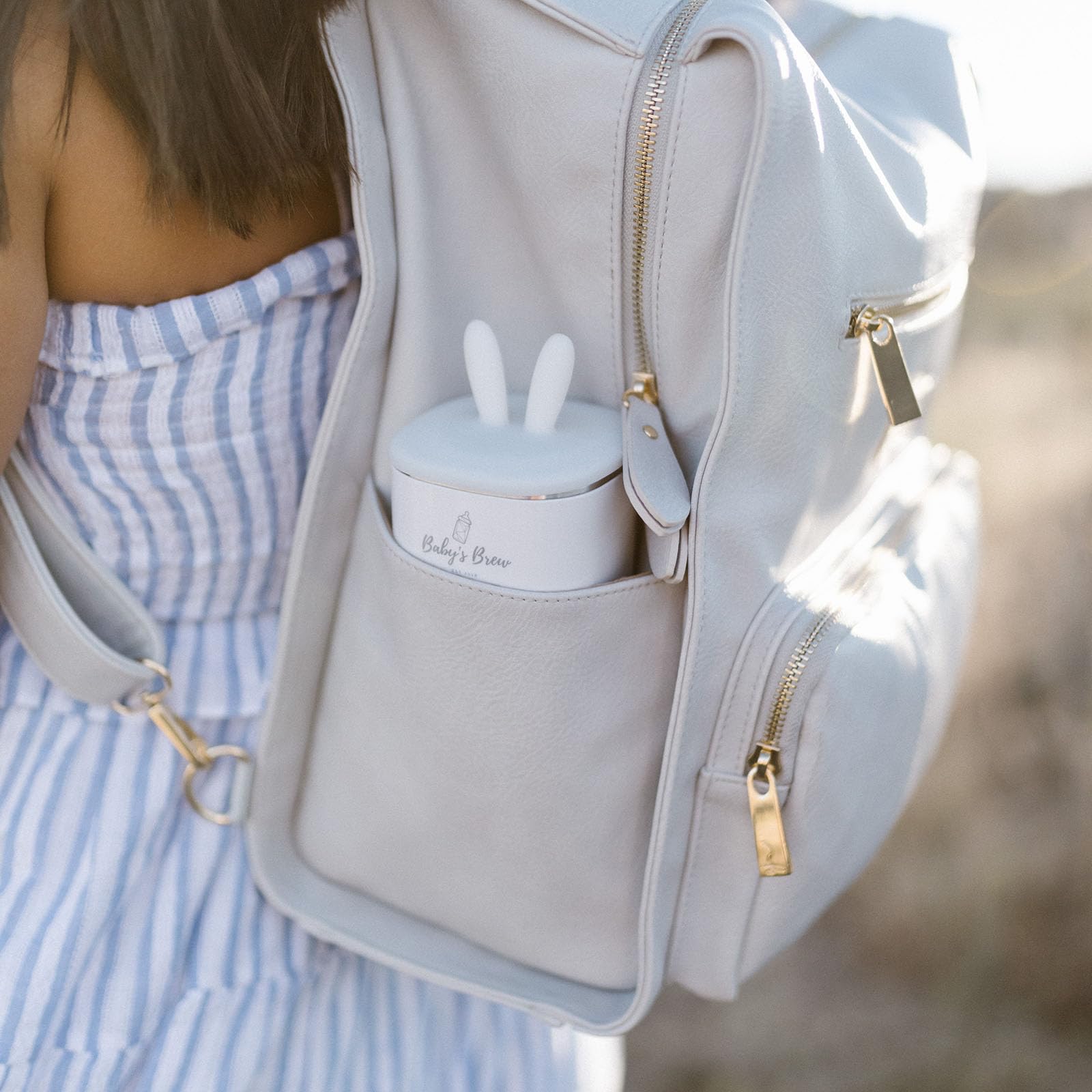 Compact travel-friendly Baby's Brew warmer inside a diaper bag