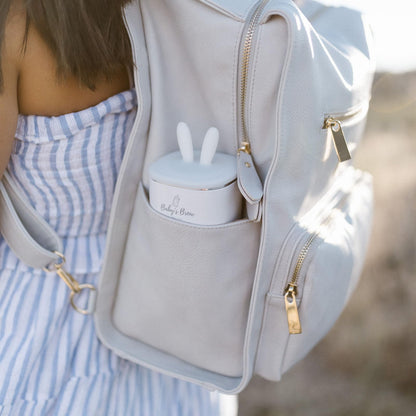 Compact travel-friendly Baby's Brew warmer inside a diaper bag