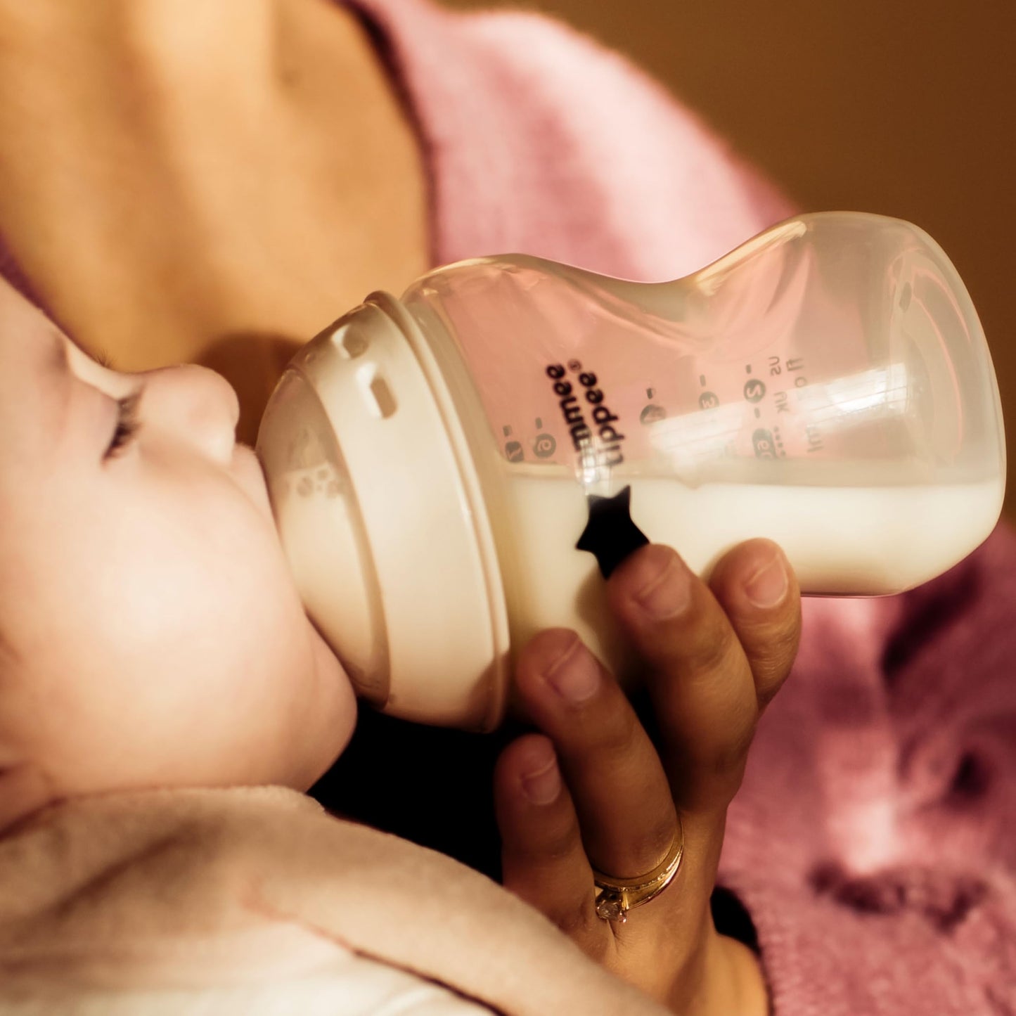 Side profile of Tommee Tippee travel bottle and food warmer in white and silver