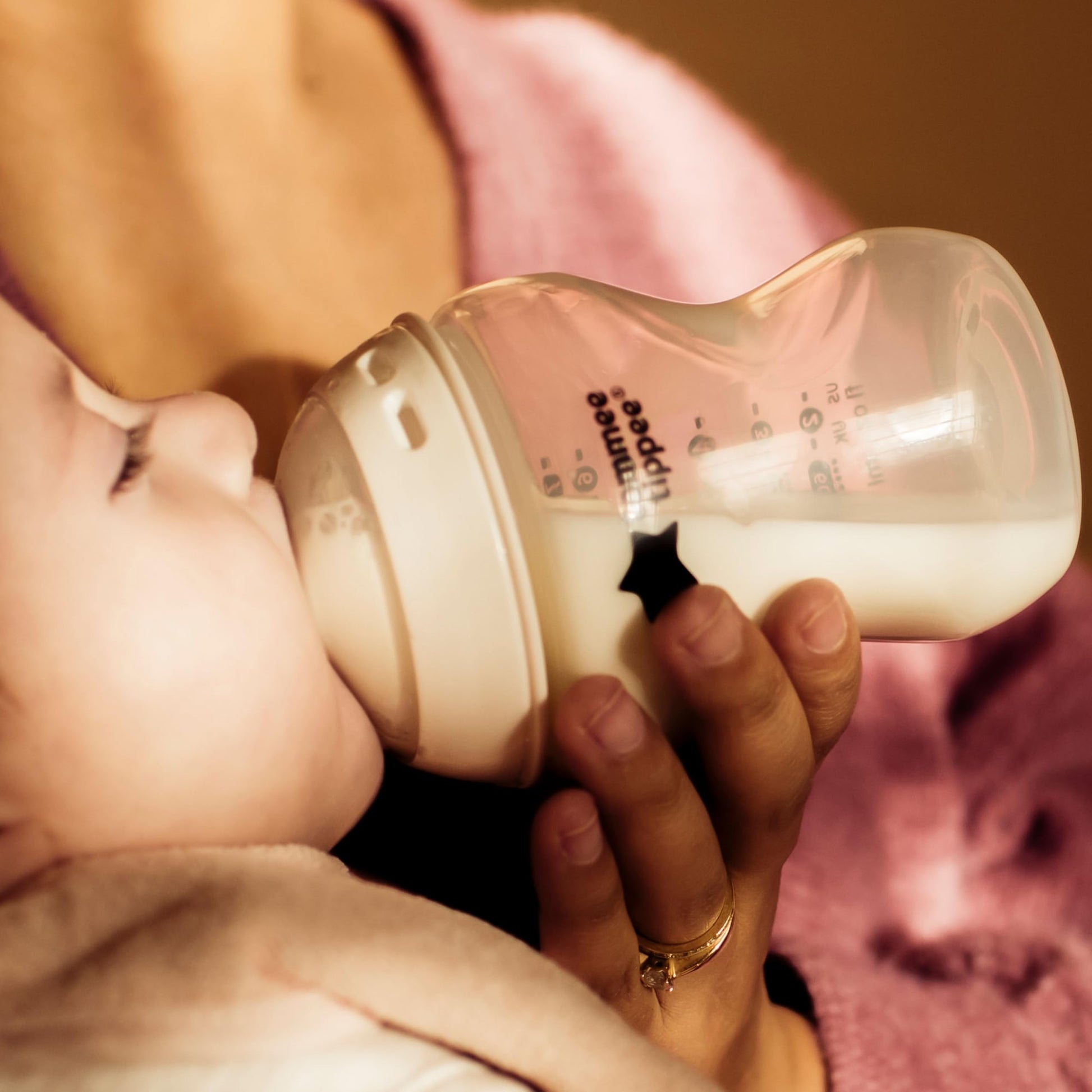 Side profile of Tommee Tippee travel bottle and food warmer in white and silver