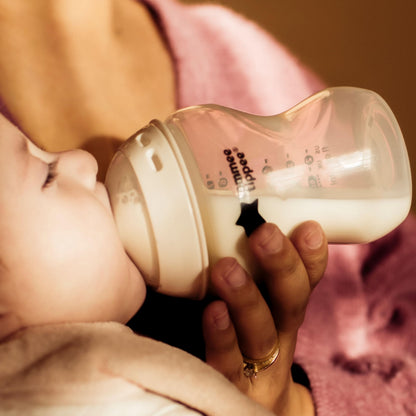 Side profile of Tommee Tippee travel bottle and food warmer in white and silver