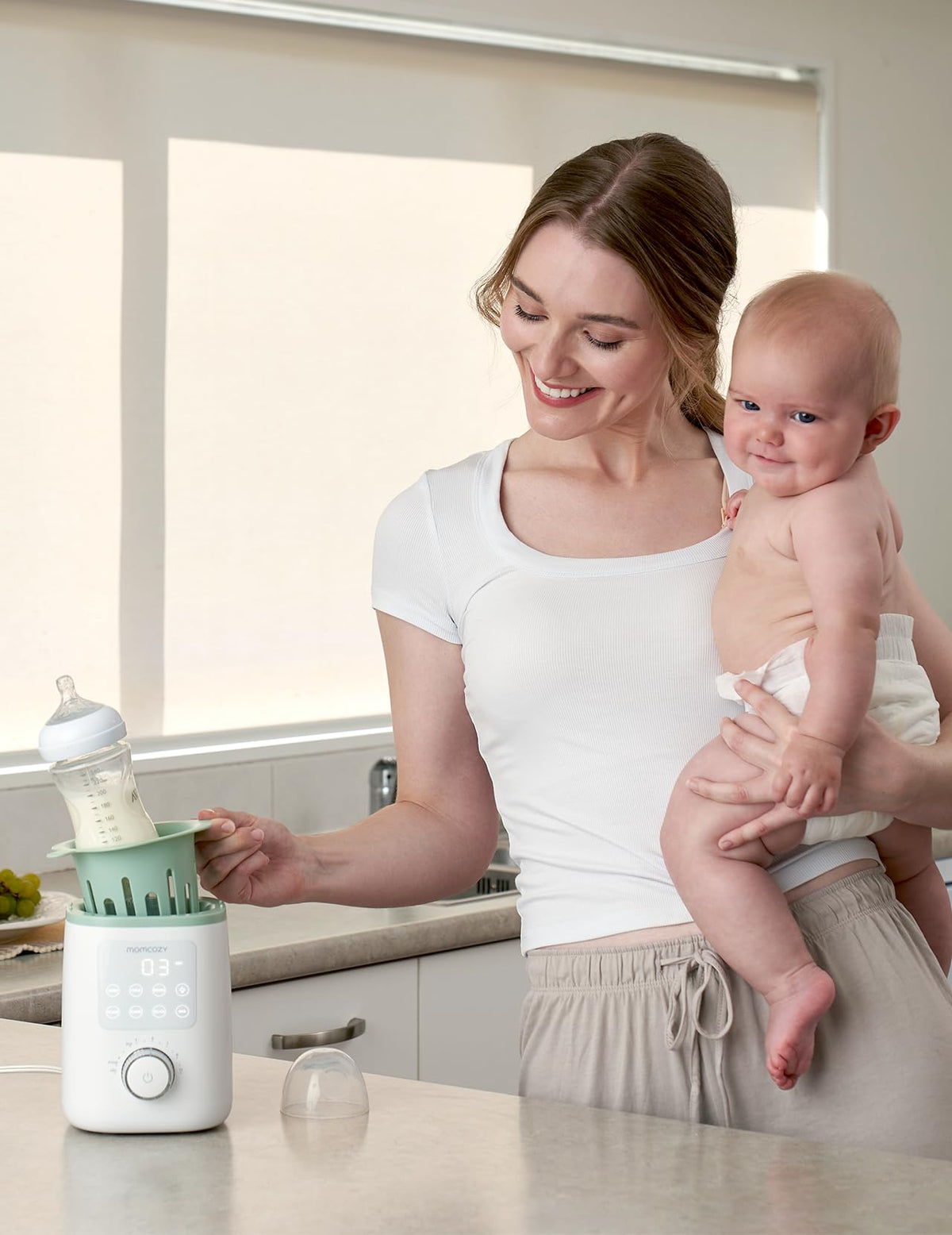 Packaging and contents of Momcozy Nutri Smart bottle warmer
