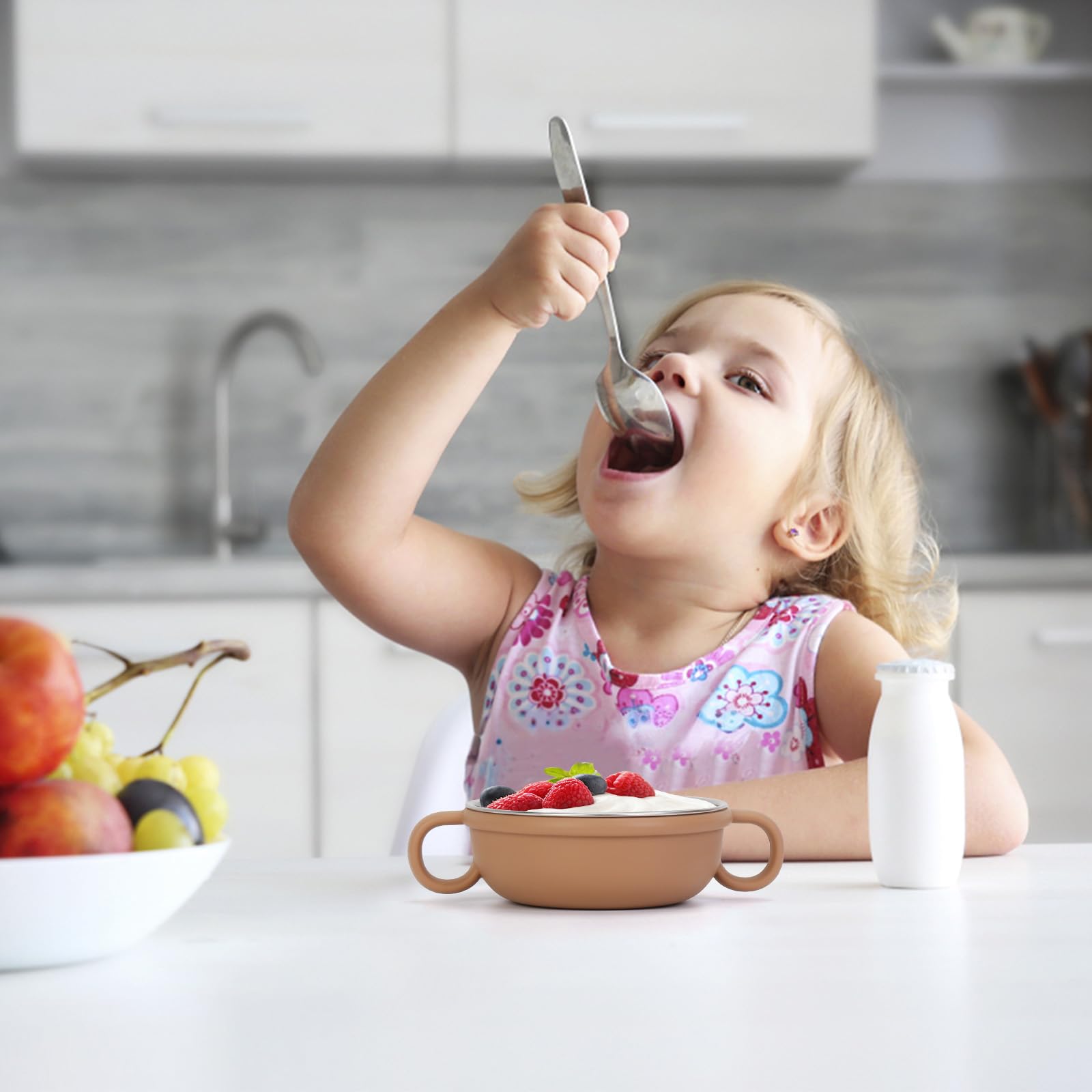 Close up of stainless steel baby bowl with colorful removable silicone sleeve