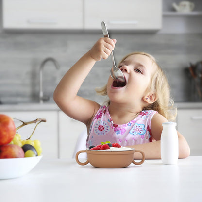 Close up of stainless steel baby bowl with colorful removable silicone sleeve