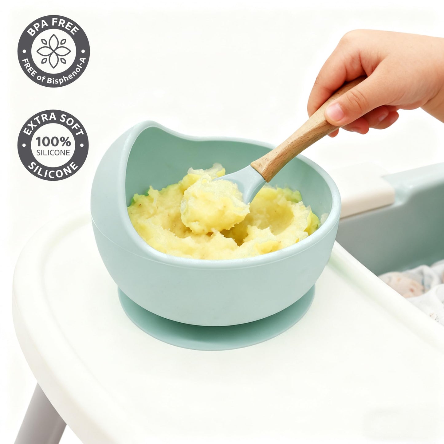 Ginbear suction baby bowl and soft training spoon on a clean high chair tray.