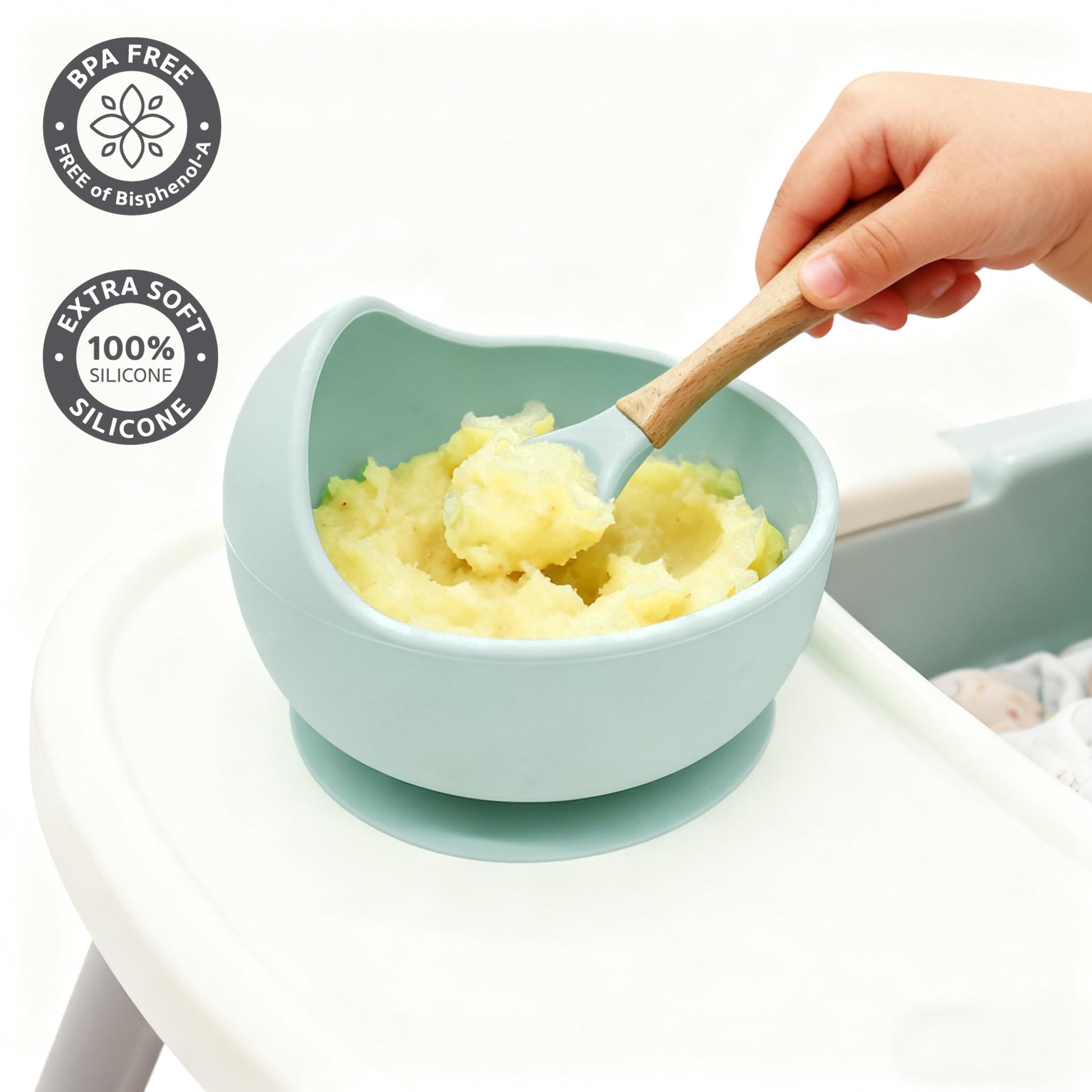 Ginbear suction baby bowl and soft training spoon on a clean high chair tray.