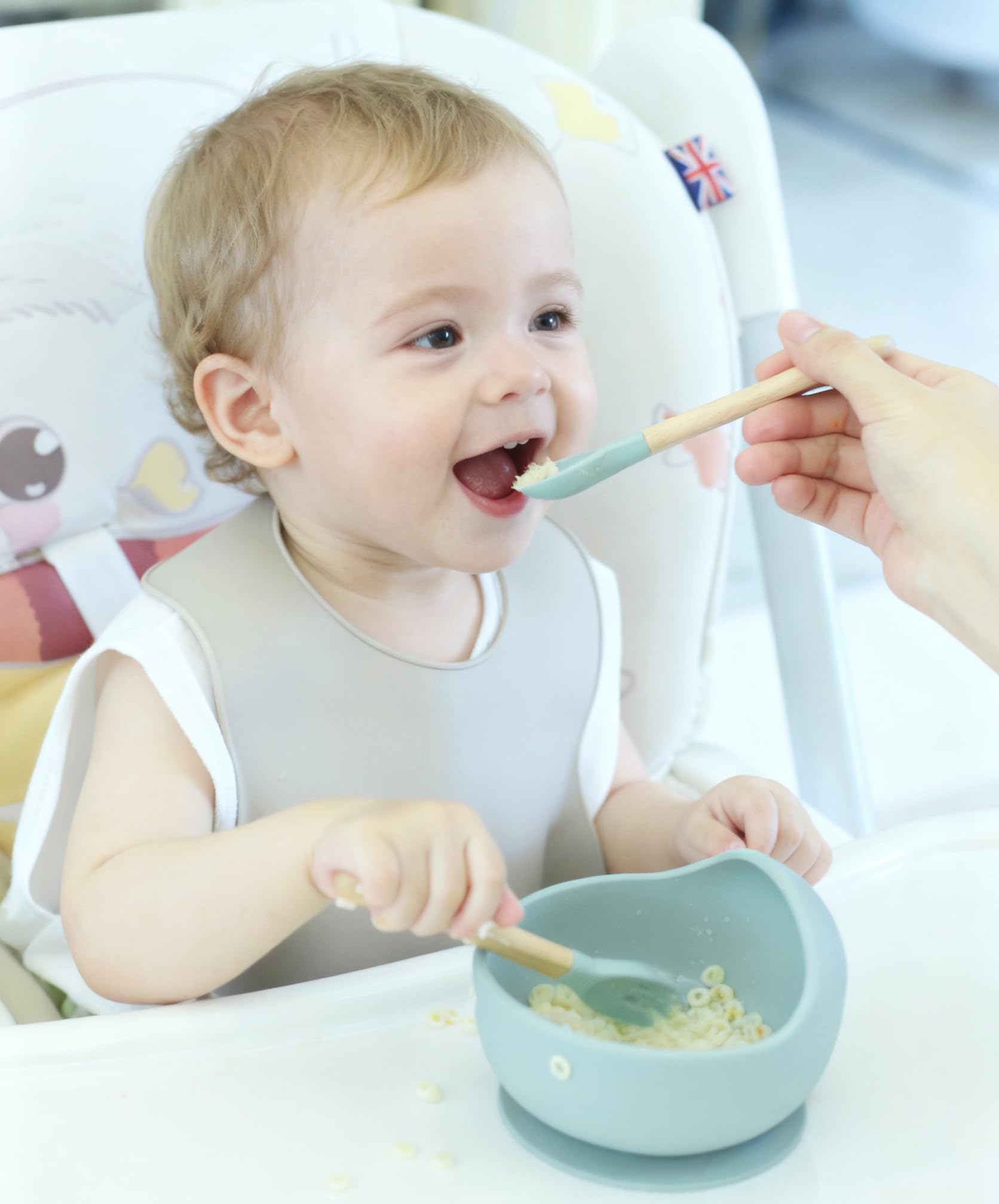 Ginbear adjustable silicone baby bib showing the wide crumb catcher pocket.