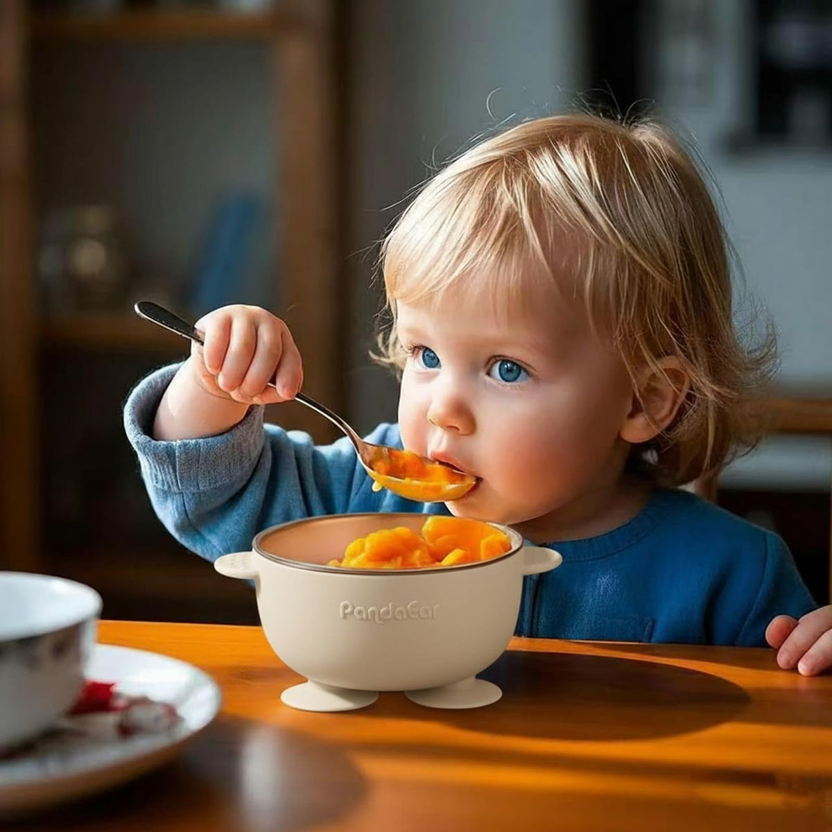Three stackable PandaEar stainless steel baby bowls with colored lids