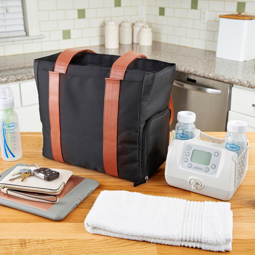 Dr. Brown's multi-use diaper bag being carried as a stylish everyday laptop tote