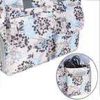 Teamoy dandelion print bag showcasing the multiple internal elastic pockets filled with pumping accessories.