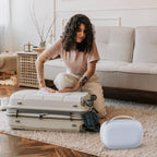 Lifestyle view of the Gowing white electronic breast pump case being placed into a mother's travel diaper bag.