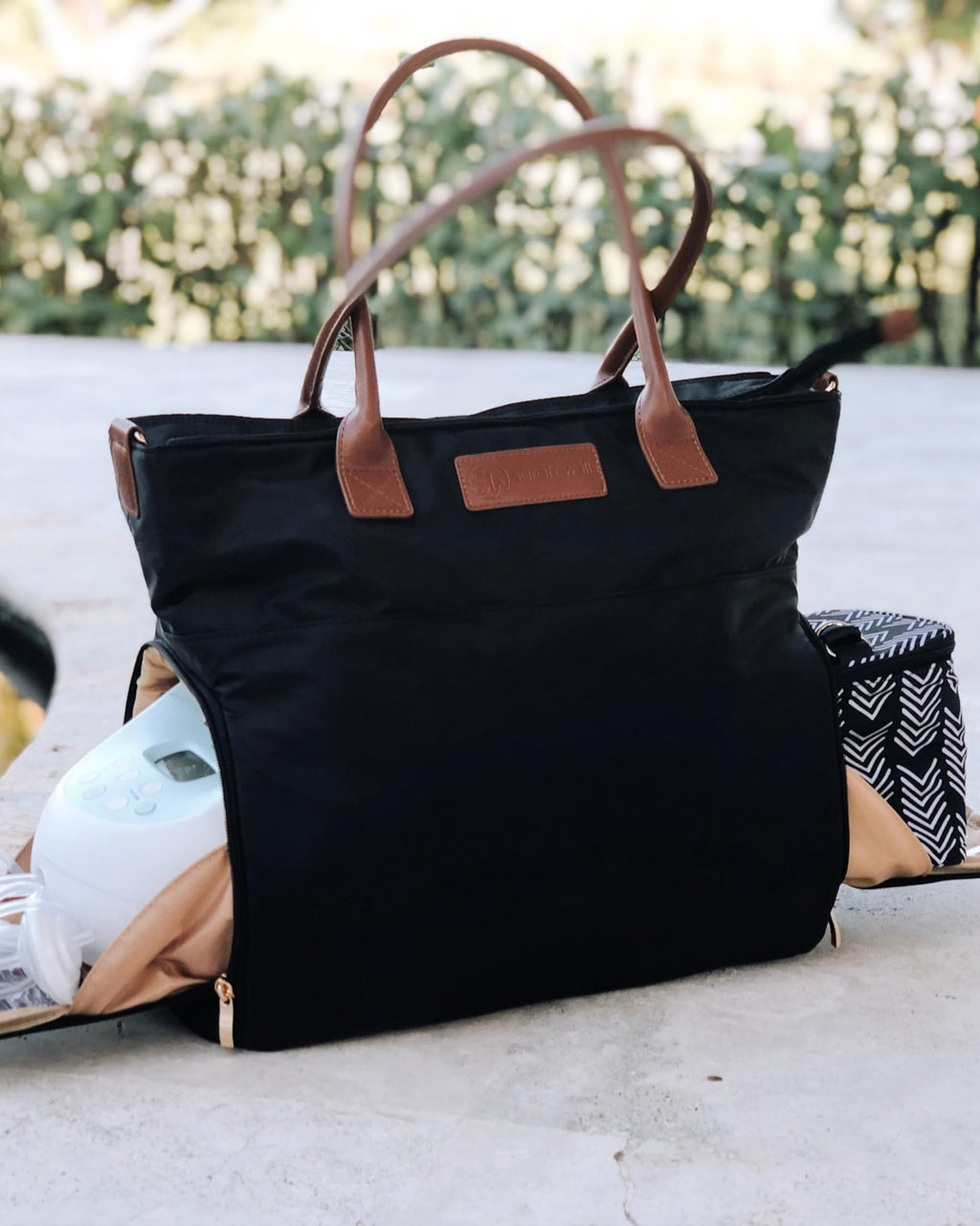 Sarah Wells Abby Tote showcasing the insulated side pocket holding a portable breast pump