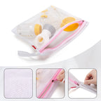 Damero breast pump storage kit showing white mesh bag