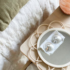 Side profile of Willow silver breastfeeding nipple covers in packaging