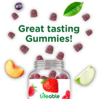 Two red vitamin B6 strawberry gummies resting beside the supplement bottle