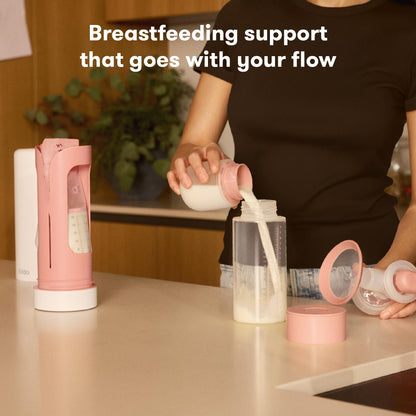 Parent pouring breastmilk into a baby bottle using the perfect-pour spout