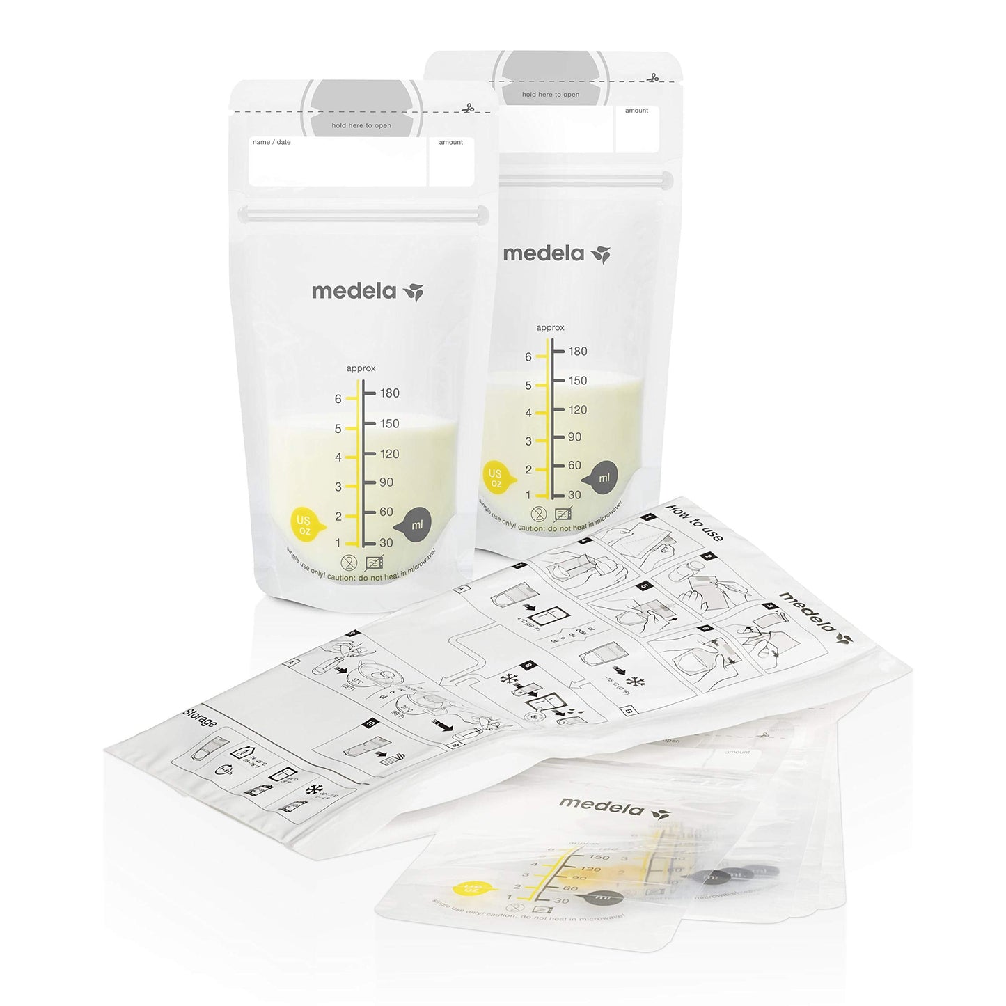 Medela breast milk bottles with yellow lids and storage tray