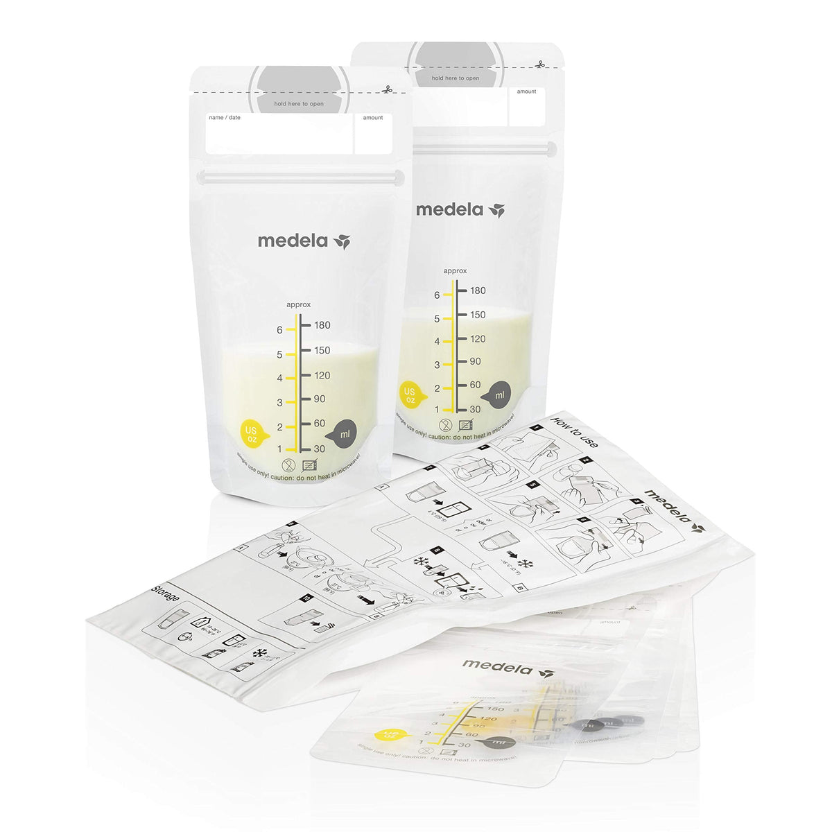 Medela breast milk bottles with yellow lids and storage tray