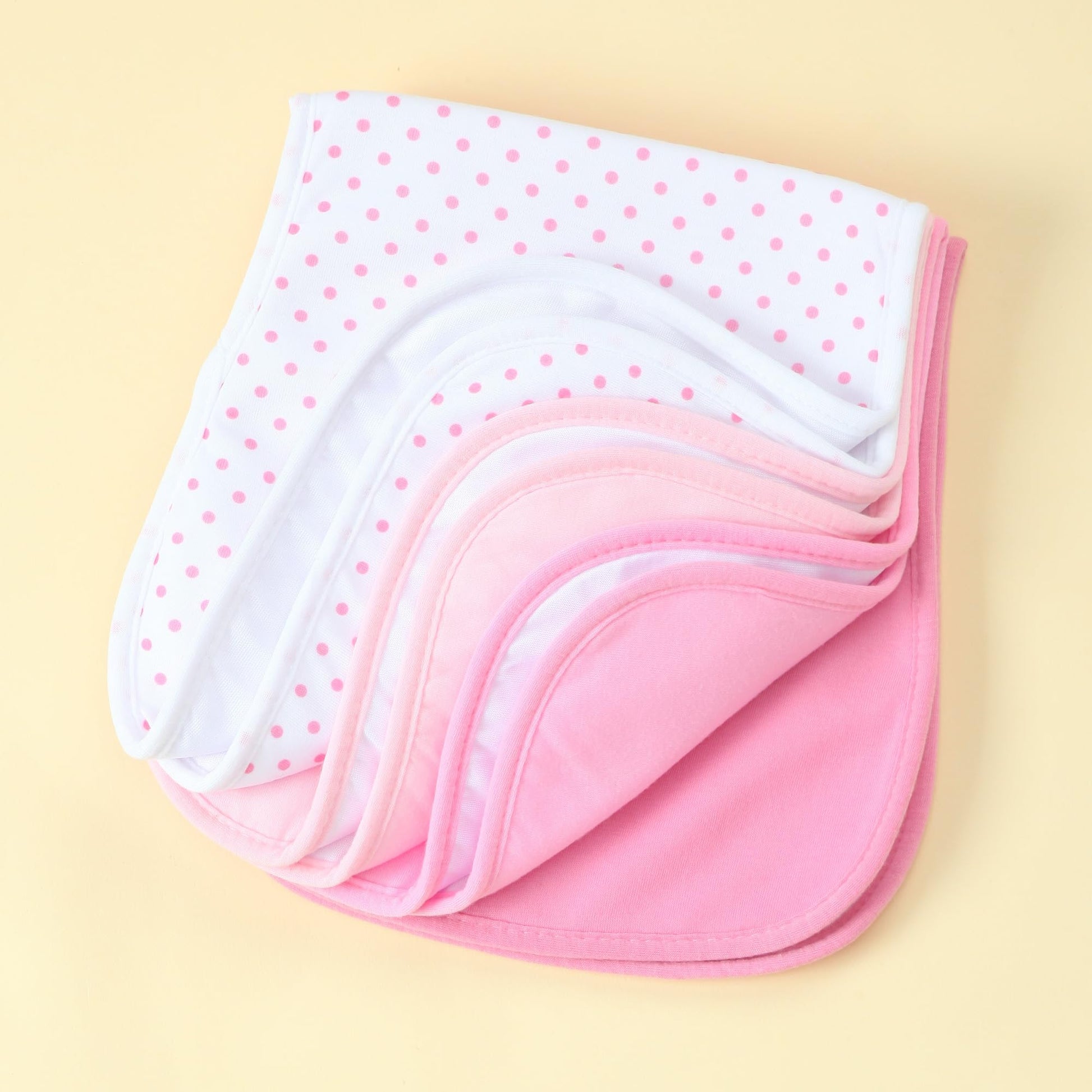 KMGDM baby burp towels folded neatly displaying the assortment of gender neutral colors