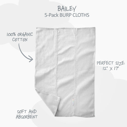 Five pieces of white baby burp cloths neatly folded highlighting the GOTS-certified knit weave.