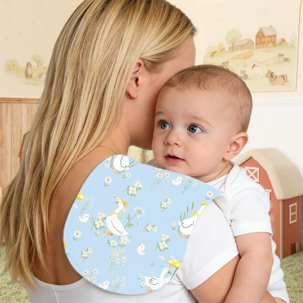 Wauprant multi layer baby spit up rags draped over shoulder demonstrating the contoured kidney shape coverage.