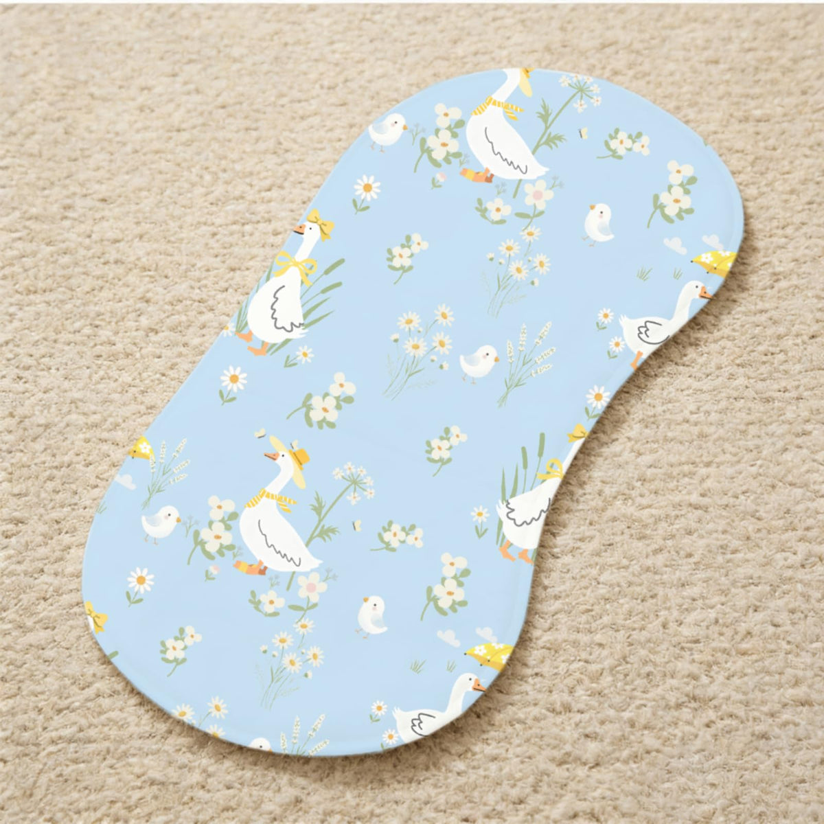 Four pieces of Wauprant whimsical goose aesthetic baby cloths folded neatly inside a modern diaper bag.