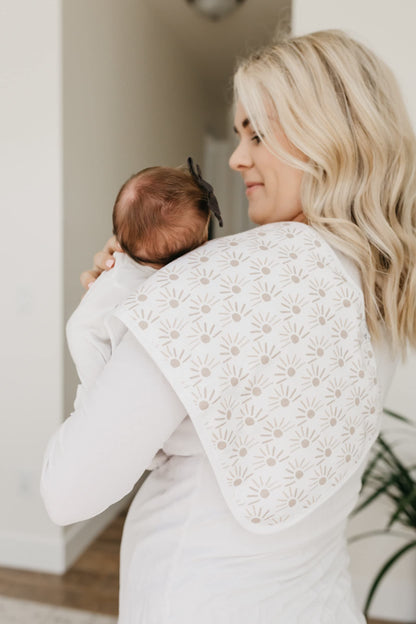 Parent using Copper Pearl burp cloth on shoulder