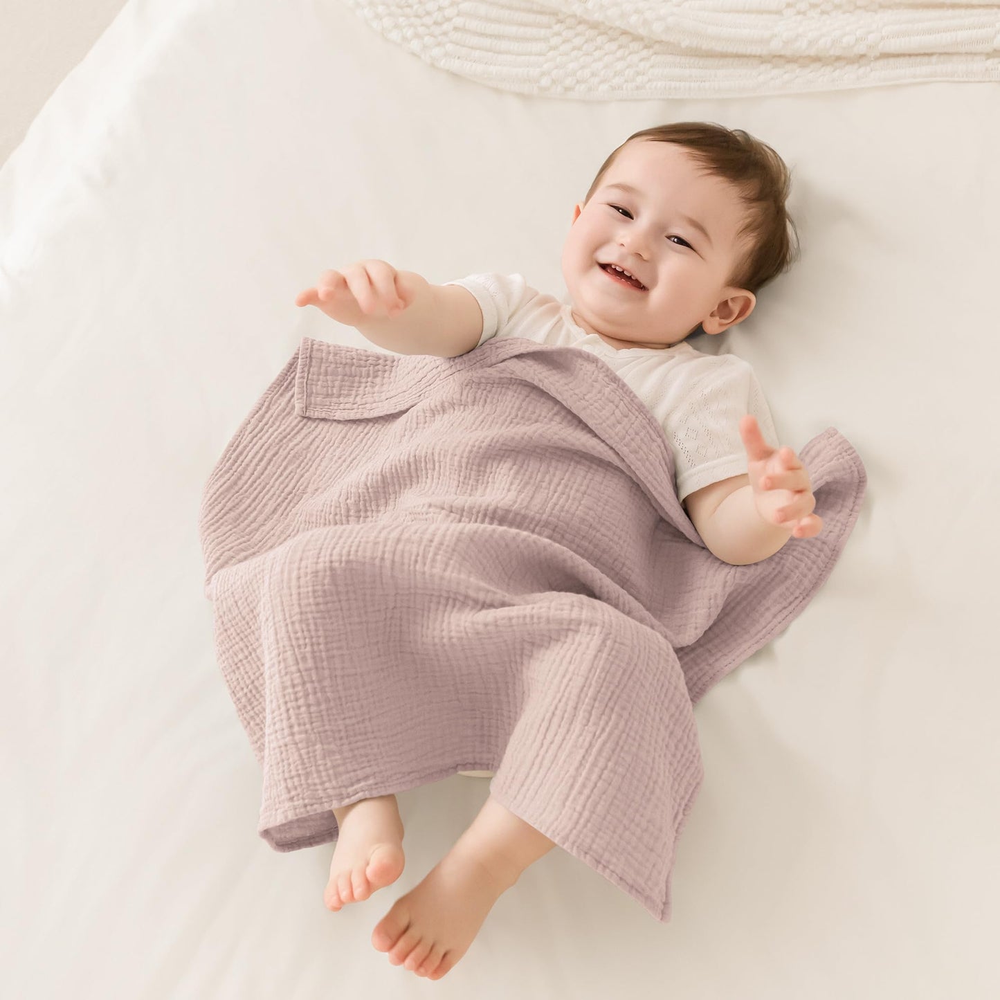 Oversized pink star muslin cloth diapers spread flat displaying the large dimensions.