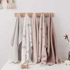 Susurration multi functional muslin towel being used as a soft face wipe.