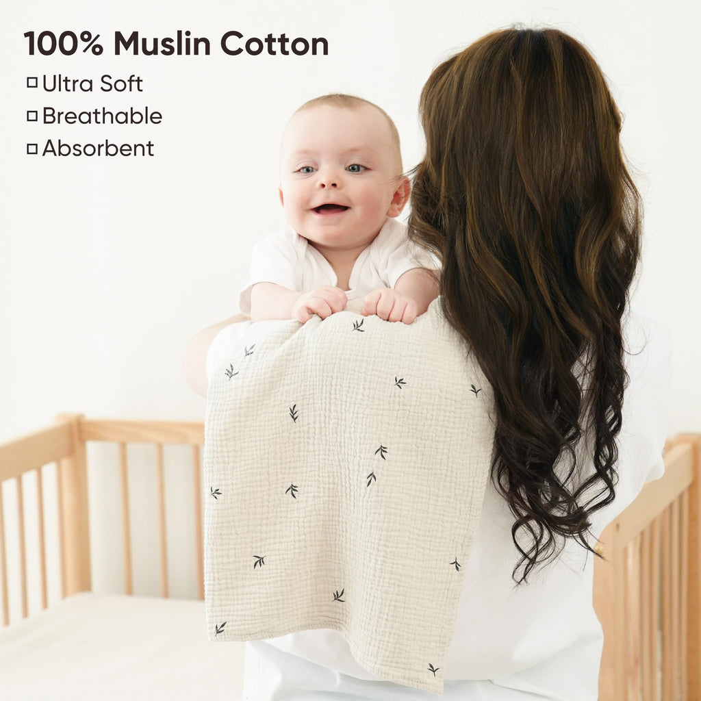 Oversized cotton newborn burping cloth draped over a shoulder for full coverage