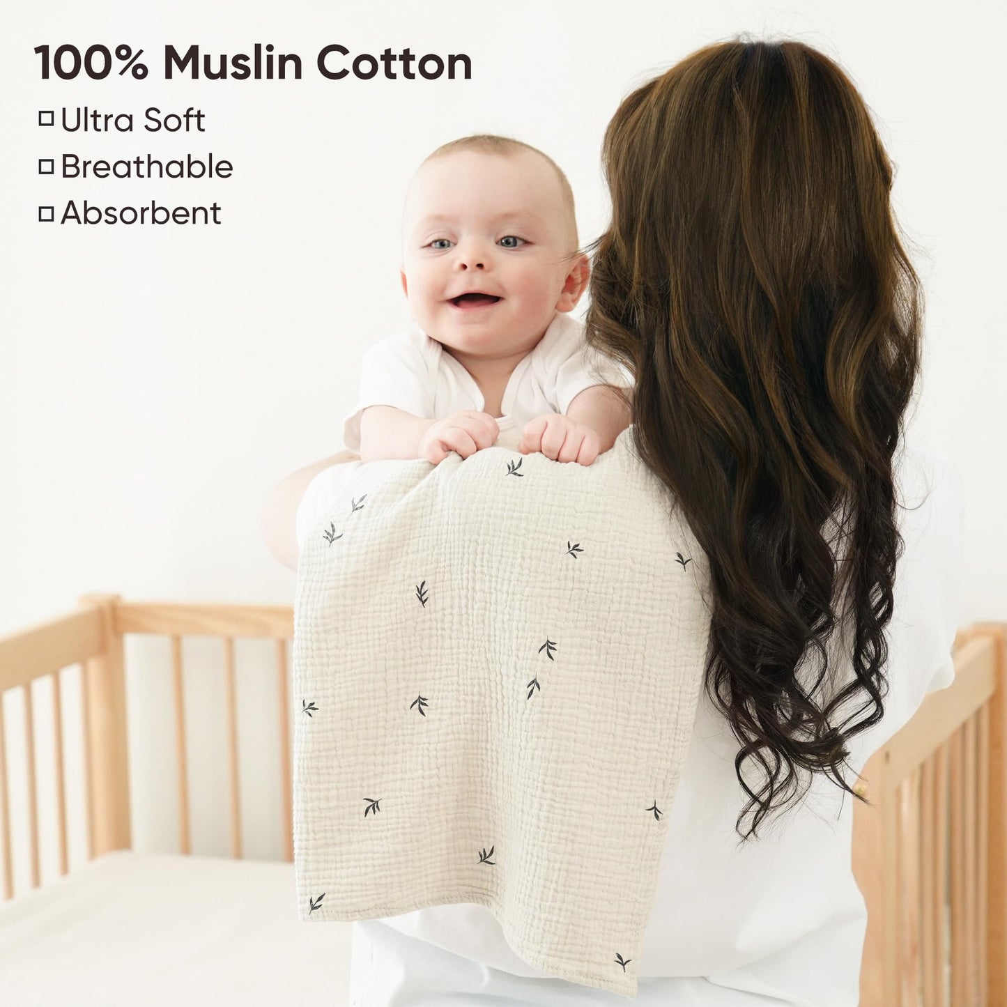 Oversized cotton newborn burping cloth draped over a shoulder for full coverage