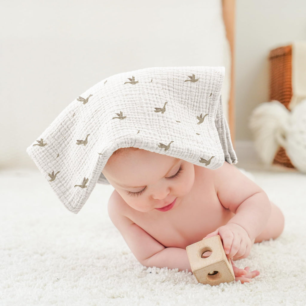 Multiuse muslin cloth being used as a soft infant bath towel