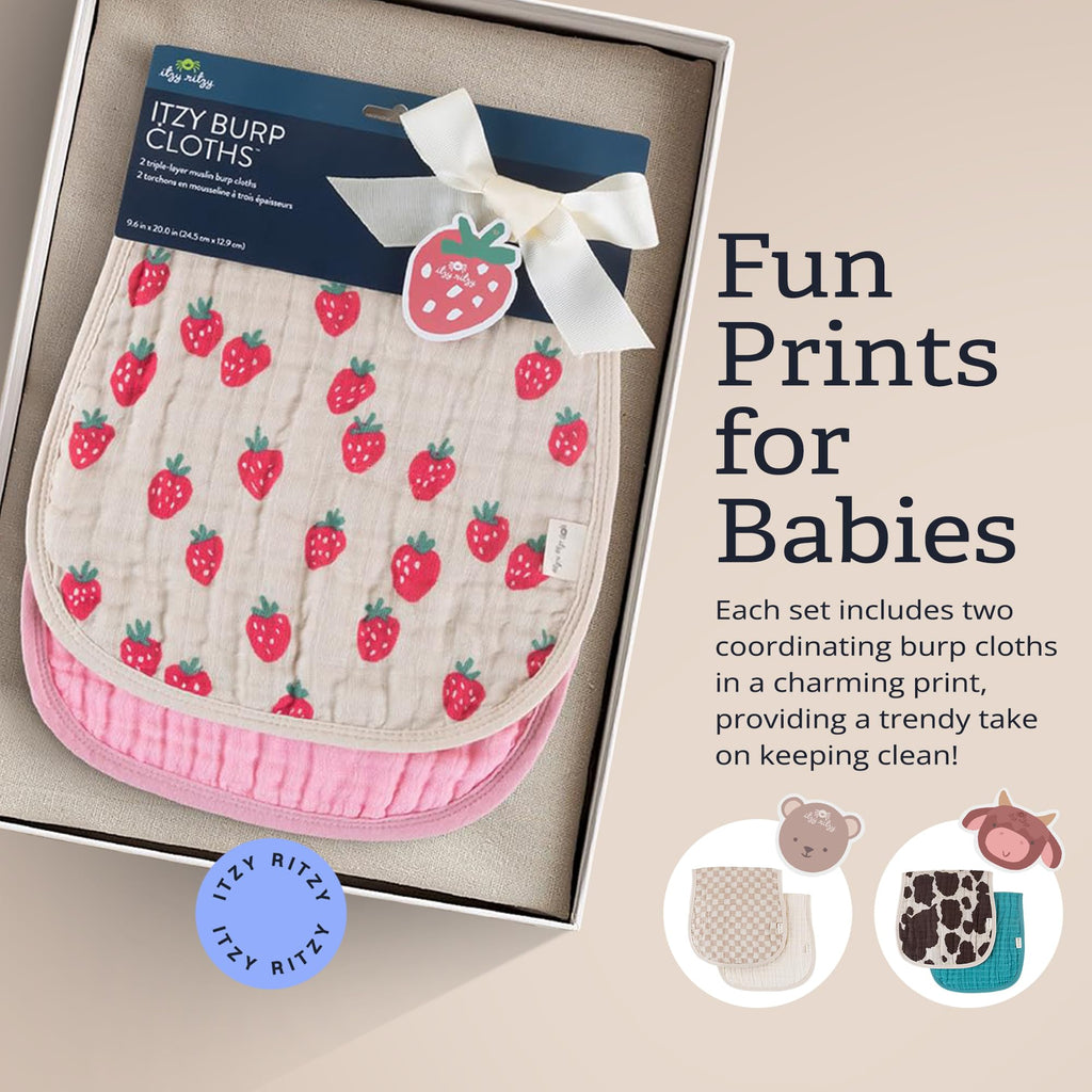 Two count set of Itzy Ritzy strawberry print muslin cloths spread out for shoulder coverage.