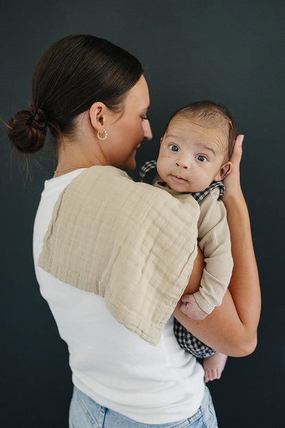 Mebie Baby muslin spit up cloths folded neatly showing the stylish western cowboy patterns.