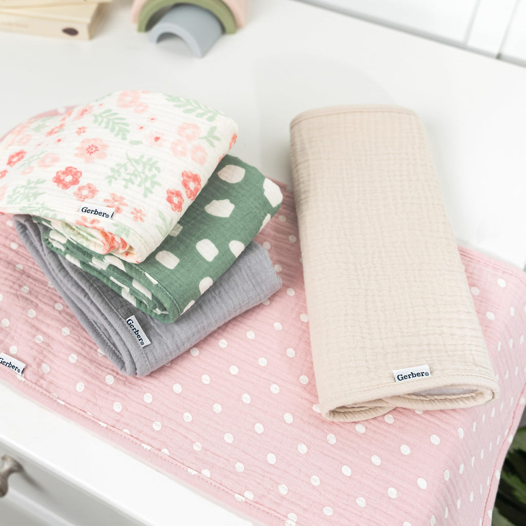 Gerber baby burp cloths showing floral and solid patterns