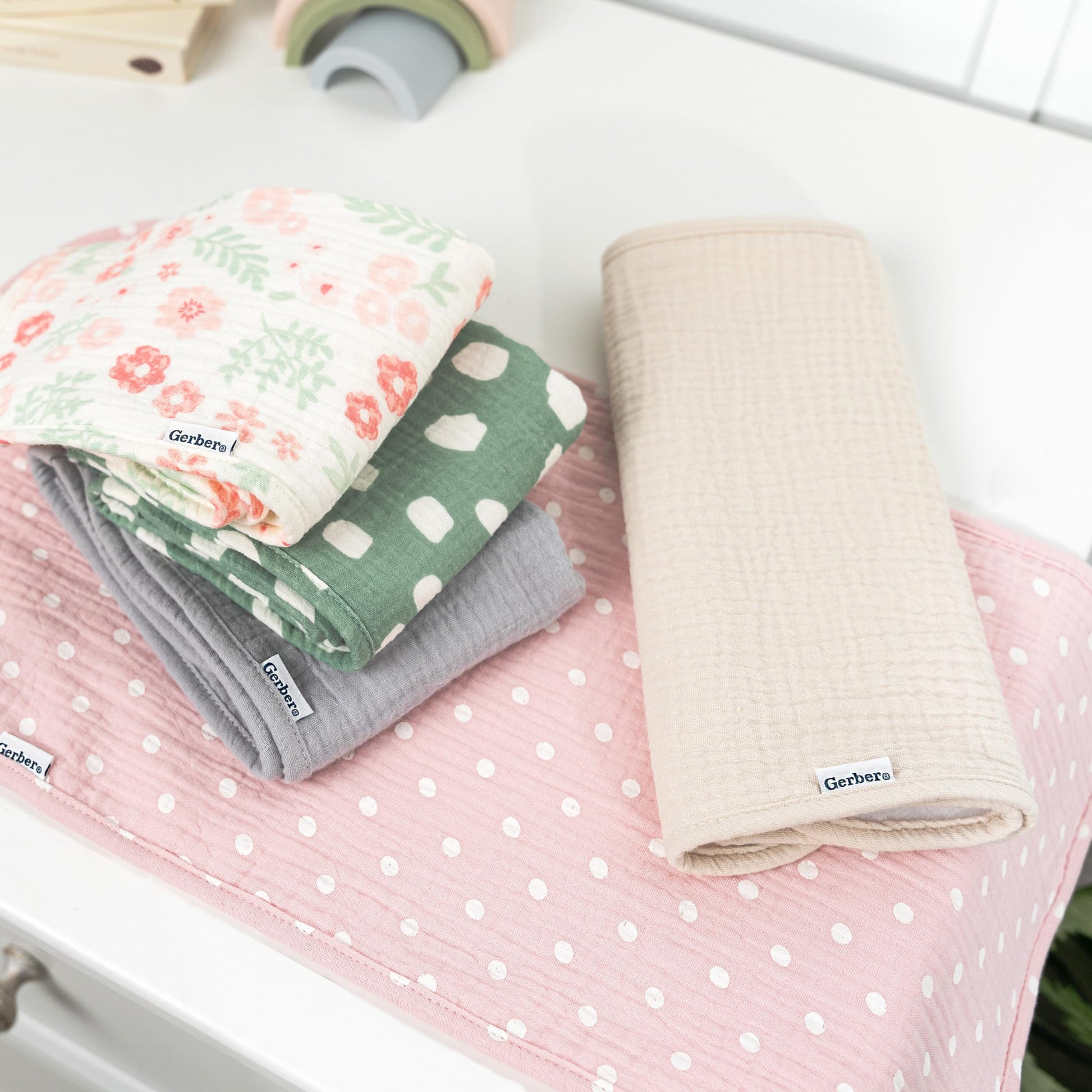 Gerber baby burp cloths showing floral and solid patterns